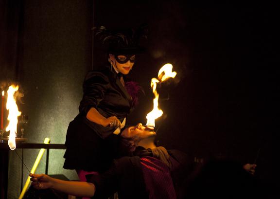 Miss Ember (Top) feeds fire to Derrick Vermin in a fiery routine at the Full Circle Brewery for the Rogue Festival, March 7. (Photo/Felisha Sanchez)