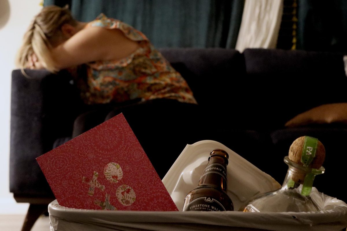 A woman poses in despair near a trashcan of her partner’s possessions. Taken on Sept. 5.