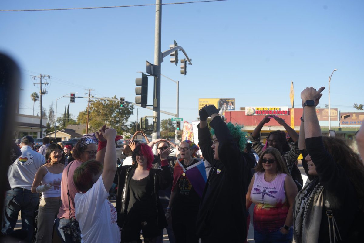 Pro-LGBTQ+ counter protestors celebrate after the WBC left the school and dance to "HOT TO GO!" by Chappell Roan on Oct. 28. 