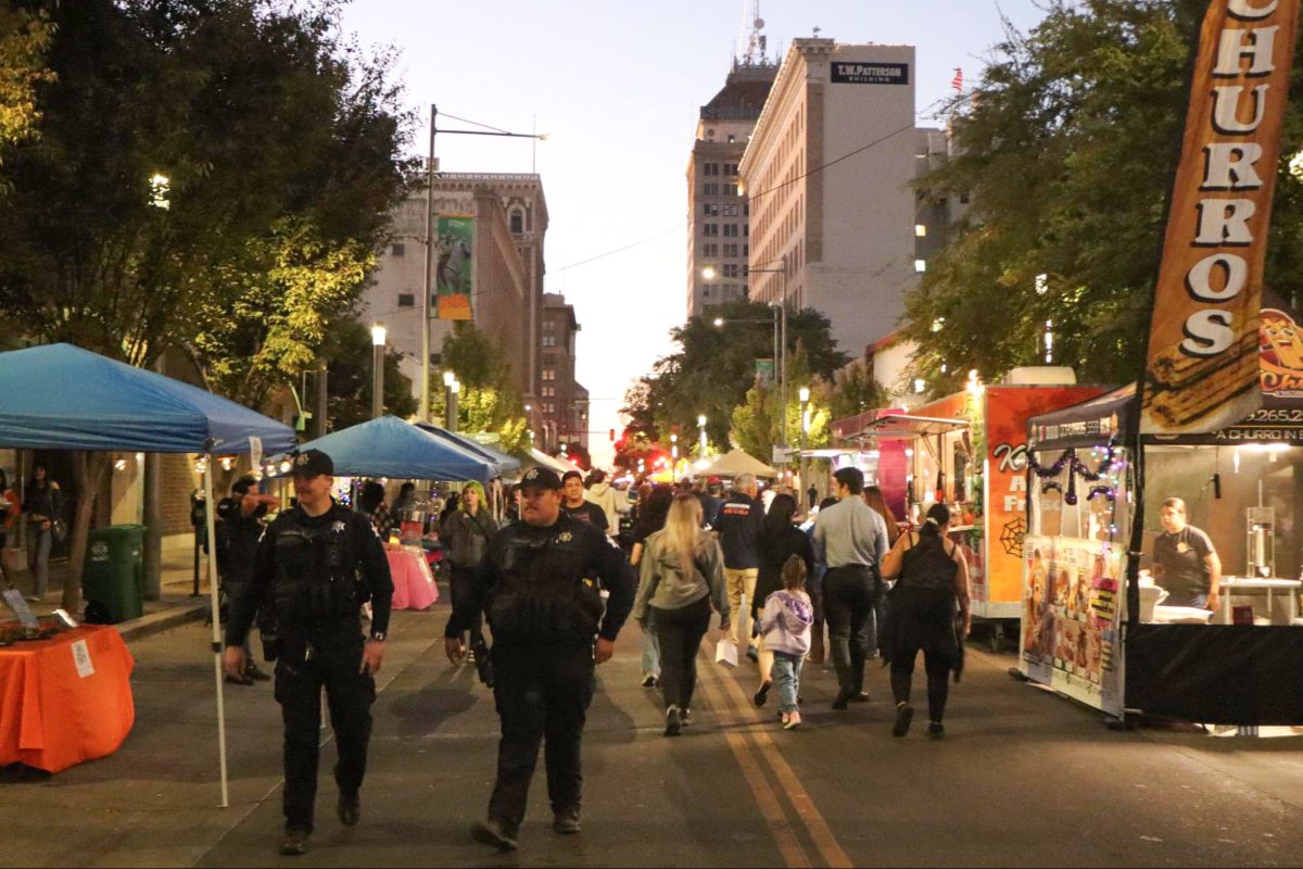 A crowd of people walk down the Fulton Mall during Why Not Wednesday on Oct. 16.