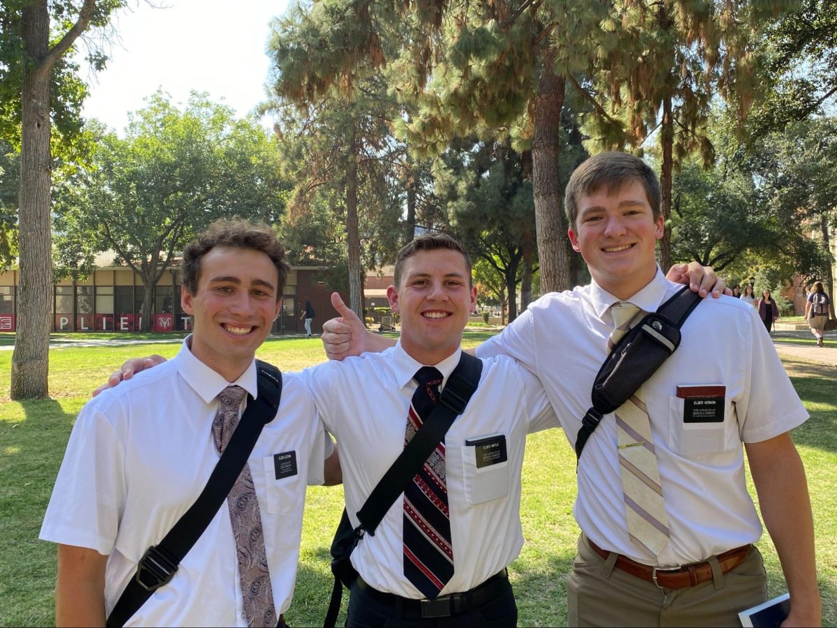 (left to right) Élder Lestina, Elder Hirtle, and Elder Vernon pose and smile on the grass outside the Ram Pantry on Oct. 9.