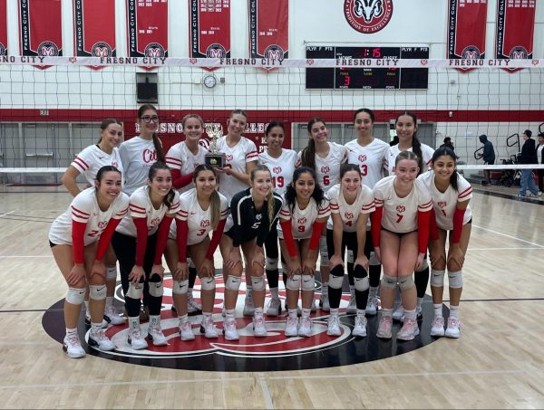 The Fresno City College women’s volleyball team pose with their championship trophy after the match against College of the Sequoias on Nov. 13. The Rams are the number one team in the Central Valley Championship conference games with a 16-0 winning streak.
