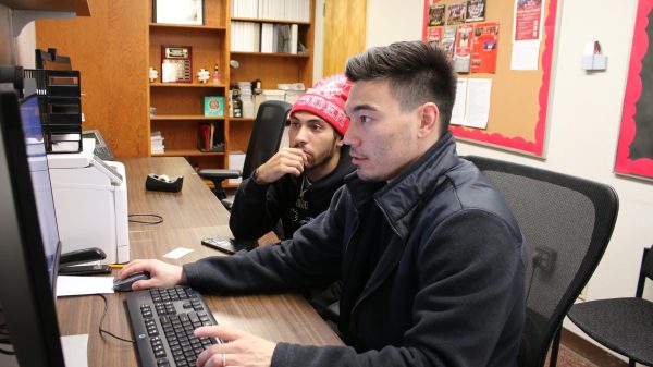 Athletic academic counselor Brandon Wong helping student-athlete Jesiah Lindsey with enrollment for the upcoming semester Nov. 22. 