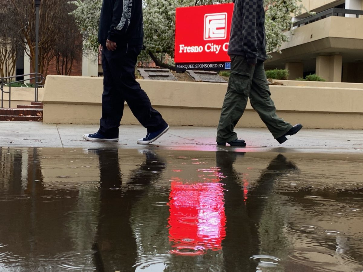 Lifestyle Editor Matthew Rodriguez (left) and Opinion Editor Apollo Soto (right) pose walking in opposite directions to symbolize the divisions created by political views at Fresno City College campus in front of the Theatre Arts building on Feb. 10, 2025.