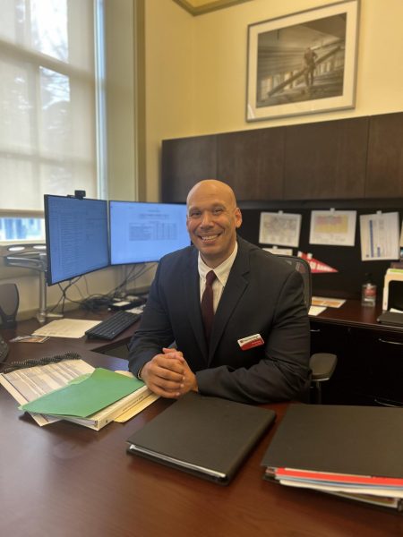 Daniel Moore poses for a picture behind his desk on Feb. 12, 2025.