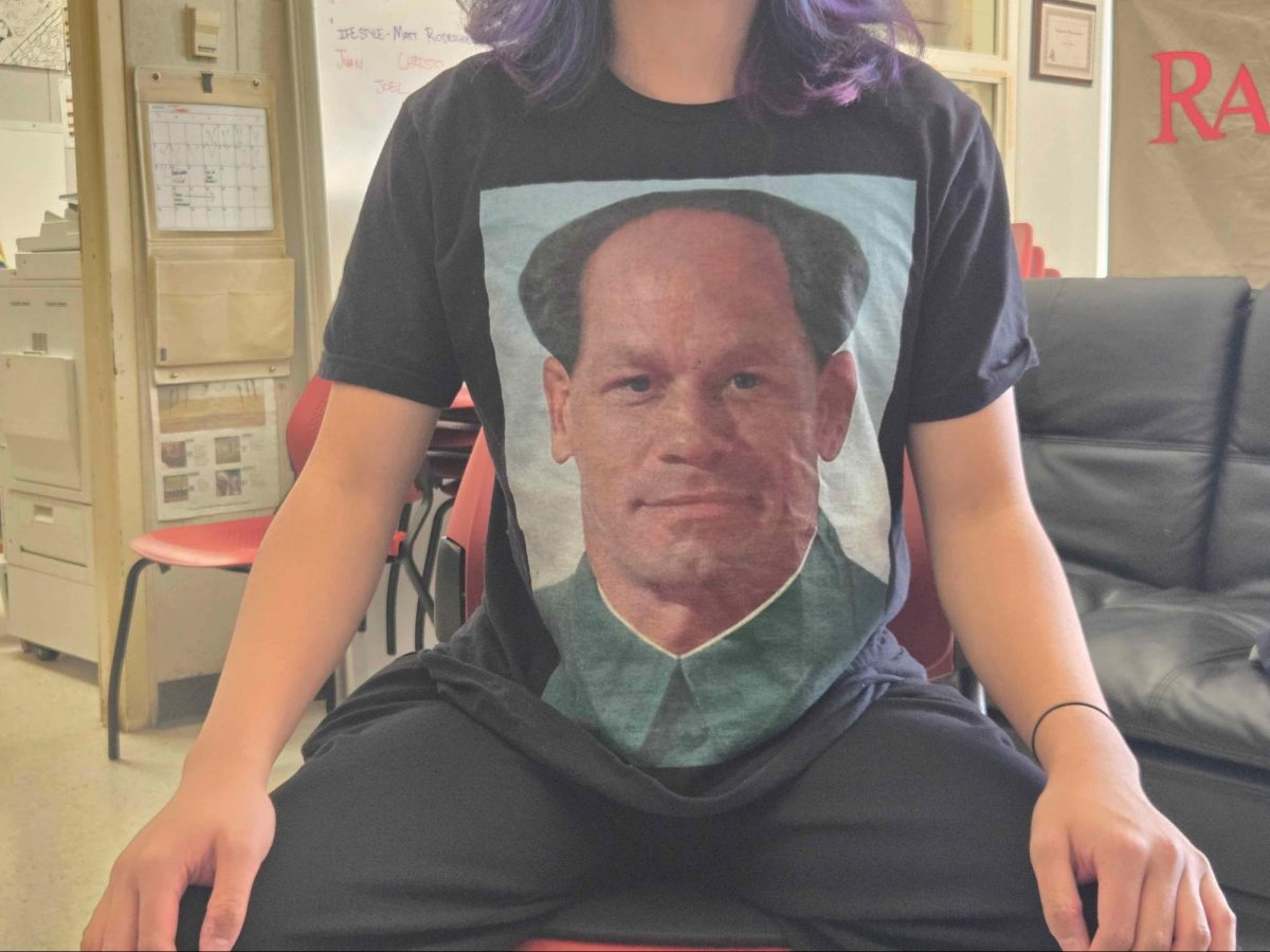 Managing Editor Matthew Echavez poses for a photo showing off a shirt featuring a mashup image of John Cena and Mao Zedong on Feb. 5.