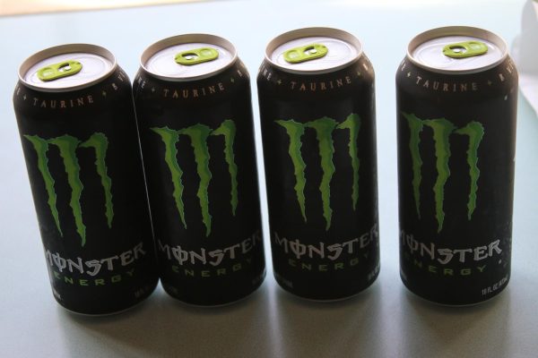 Four Monster cans which contain a high amount of caffeine each stand in a row on Feb. 21, 2025. Photo by Justin Shaw.