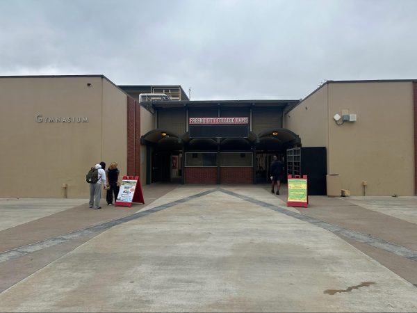 A pair of students walk into the gym to retrieve their items left behind after the Gymnasium was evacuated due to a gas leak on Feb. 25, 2025.
