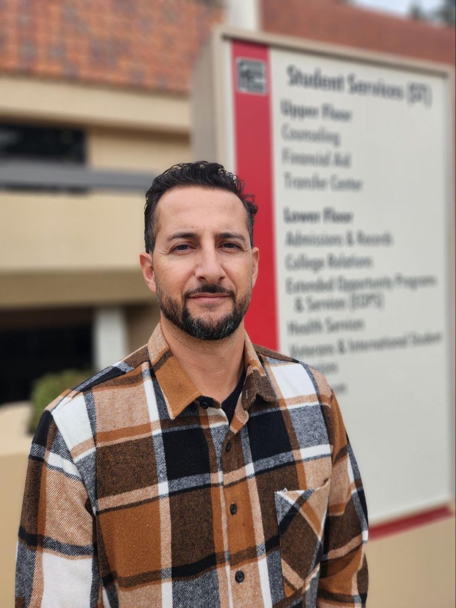 Counselor Ernesto Cazares poses in front of Student Services at Fresno City College on Dec. 13, 2024.