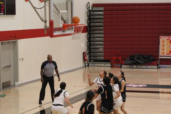 Fresno City College women’s basketball and Reedley women’s basketball players battling over a rebound on Feb. 19. 
